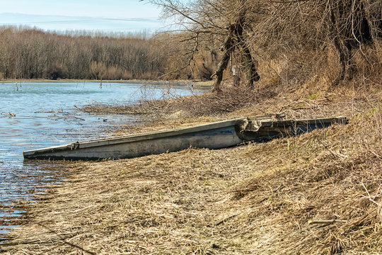 abandoned and damaged wooden boat on the coast