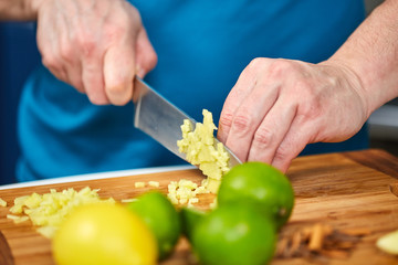 Man chopping fresh ginger