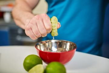 Man squeezing a lime