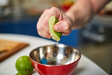 Man squeezing a lime