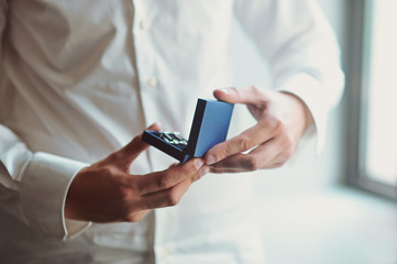 Men's accessories. Silver cufflinks in a box in hands of businessman