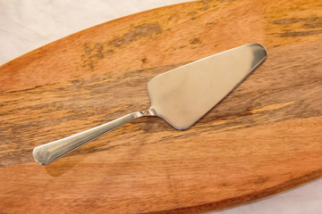 metal pizza turner on the cutting board
