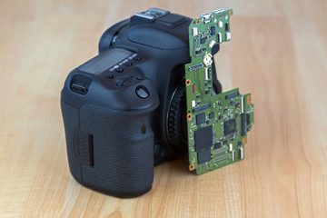 Motherboard Main board for Digital camera replacement on wooden background.