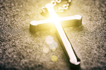 Silver cross on a gray background