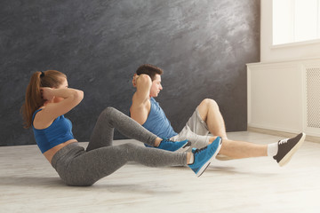 Fototapeta na wymiar Fitness couple lying doing crunches
