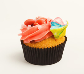Tasty muffin with buttercream isolated on white