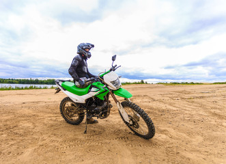 Fototapeta na wymiar Motocross racers on landscape
