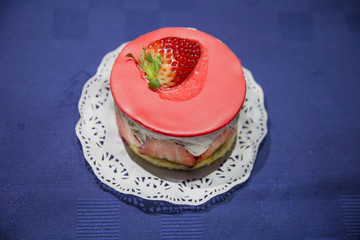 strawberry cake and strawberries on brown wooden board