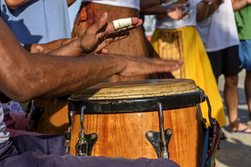 Percussionist playing atabaque during folk samba performance on the streets of Rio de Janeiro