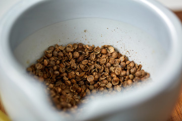 Oregano seeds in a mortar