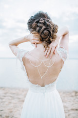 Young pretty woman in elegant dress. Back view bridal fashion background. Monochrome.