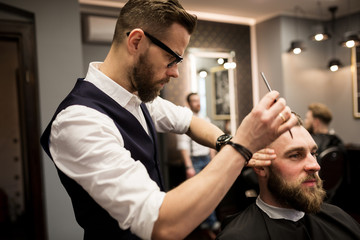 Barber focused on working on customer hair