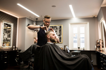 Smiling man having hair cut in salon