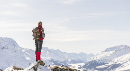 Switzerland, Engadin, hiker in mountainscape looking at view