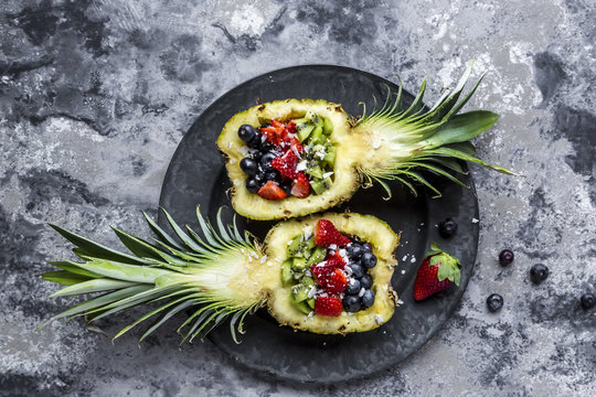 Sliced ananas with fruits, kiwi, strawberry and blueberry