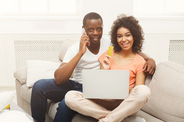 Young african-american couple shopping online