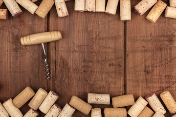 Wine corks and a corkscrew on a dark wooden background with a place for text