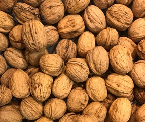 Pile of fresh ripe walnuts, traditional Christmas snacks, mediterranean produce rich in omega 3, healthy and nutritious snacking