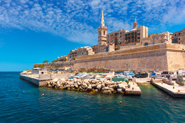 Valletta Skyline with fortress wall, boat pier and St. Paul's Anglican Pro-Cathedral, Valletta, Capital city of Malta. View from the sea - obrazy, fototapety, plakaty