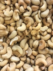 Close up of cashew nuts, heap of cashew nuts as background, raw and roasted nuts, healthy snacking, plant based diet