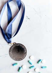 Concept of doping in sport - deprivation medals top view