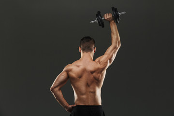 Fototapeta na wymiar Back view portrait of a young shirtless muscular sportsman