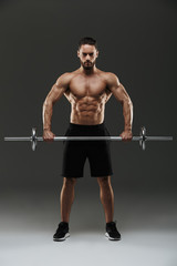 Full length portrait of a strong shirtless muscular sportsman