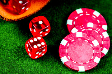 poker chips and dice on green background top view