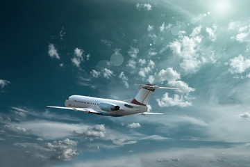 Naklejka na ściany i meble Airplane at fly on the sky with clouds