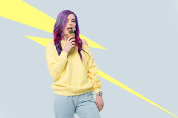 Young woman holding cactus plant in ice cream waffle cone on creative background