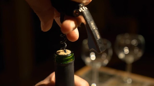 Pulling a cork from a bottle of wine