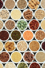 Macrobiotic health food with legumes, seeds, nuts, grains, cereals and whole wheat pasta with super food high in protein, omega 3, anthocyanins, antioxidants, fibre, minerals and vitamins. Top view.  