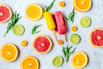 homemade ice-cream with oranges and lime on table top view patte