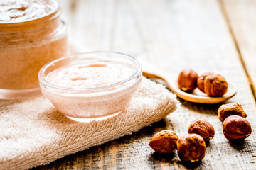 spa concept with hazel-nuts and scrub on wooden background