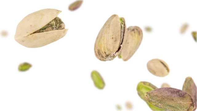Pistachios (whole and kernels) falling down on white background (45 degrees, not loopable)