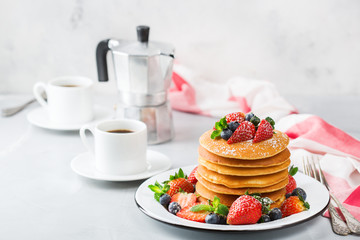 Stack of homemade pancakes for breakfast with berries
