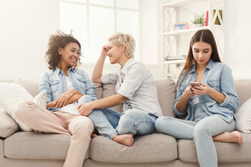 Three female friends relaxing at home