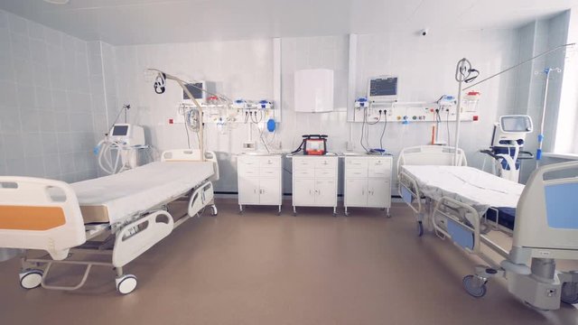 Fully-equipped spacious hospital ward with two empty beds