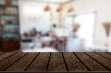 Selected focus empty brown wooden table and Coffee shop or restaurant blur background with bokeh image. for your photomontage or product display.