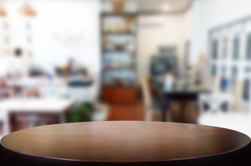 Selected focus empty brown wooden table and Coffee shop or restaurant blur background with bokeh image. for your photomontage or product display.