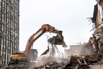 Hydraulic crusher excavator working on a demolition site