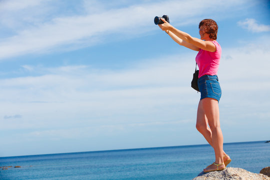Adult woman taking pictures
