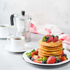 Stack of homemade pancakes for breakfast with berries