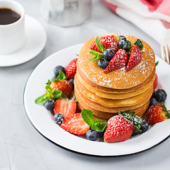 Stack of homemade pancakes for breakfast with berries