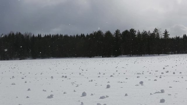 snowfall and sunshine, snow on a frozen lake with snowballs shaped by the wind