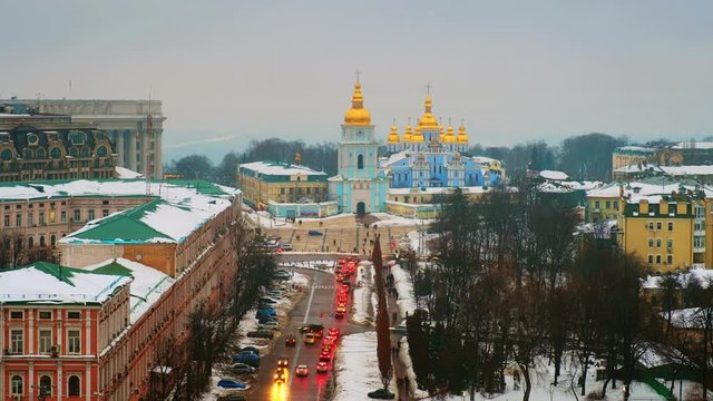 Kiyiv, Ukraine. A video of sunset in Kyiv, Ukraine, with a view of the St Michaels Golden - Domed Monastery and traffic on a winter day with a gloomy sky. Time-lapse at sunset with illumination
