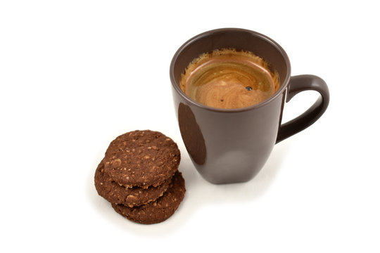 Coffee and biscuits stock images. Cup of coffee on a white background. Brown cup of coffee with snack. Cup of coffee with cookie. Espresso with sweetness