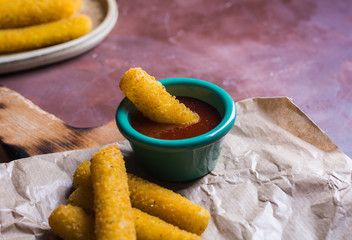 Mozzarella sticks coated with hot sauce.