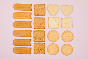 The food is laid out geometrically correctly, in rows. Biscuits of different shapes, flour products