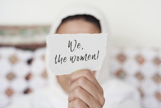 woman with a hijab and the text we the women